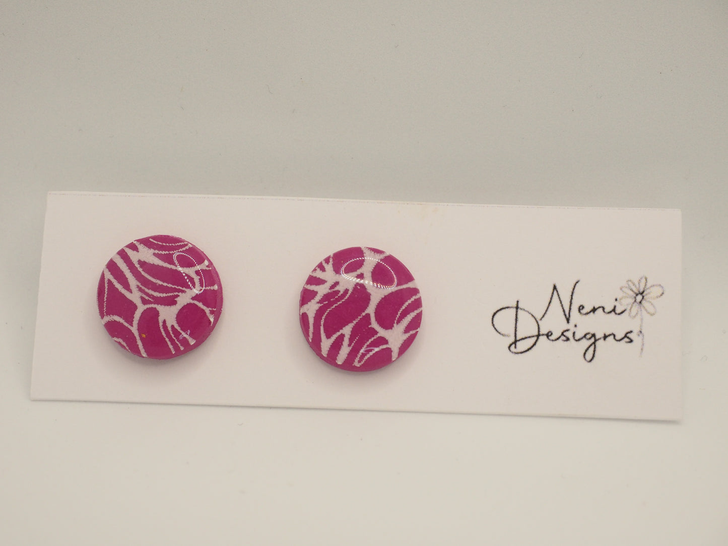 small round stud (purple and white)