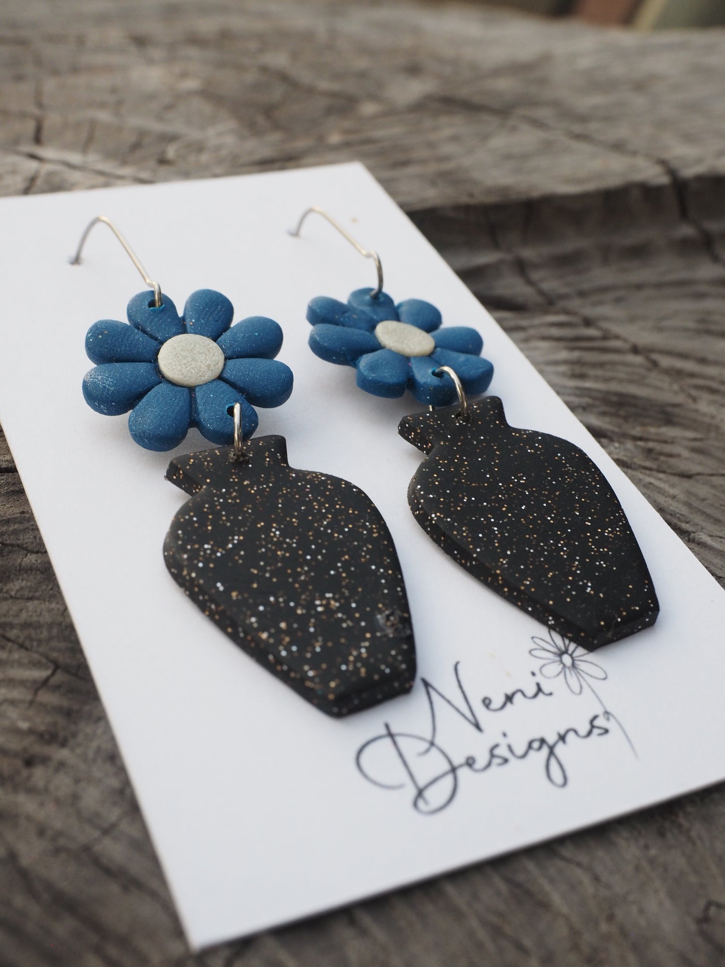 'floral' (dark blue flower with glittery black vase)